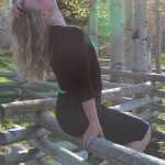 Lauren aching her neck, illuminated by sunlight