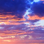 Photograph by CallyAnn Hamilton of a dazzling sunset in hues of purple, pink, cobalt and gold.